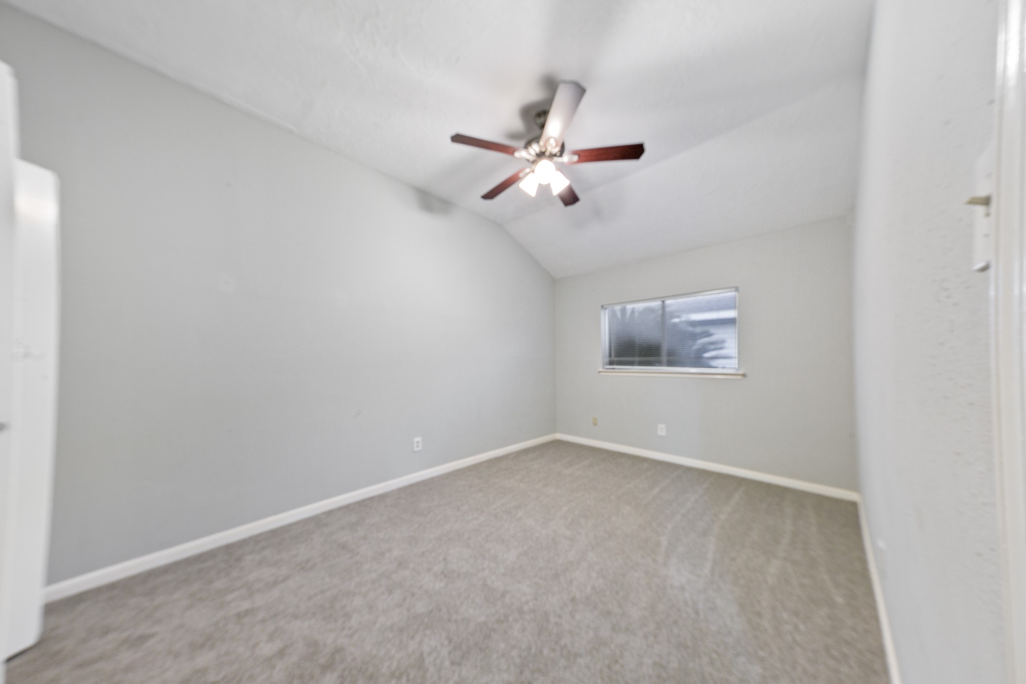 10530 Rippling Fields Drive Houston, TX 77064 - Photo 27 of 30 an empty room with a window and ceiling fan