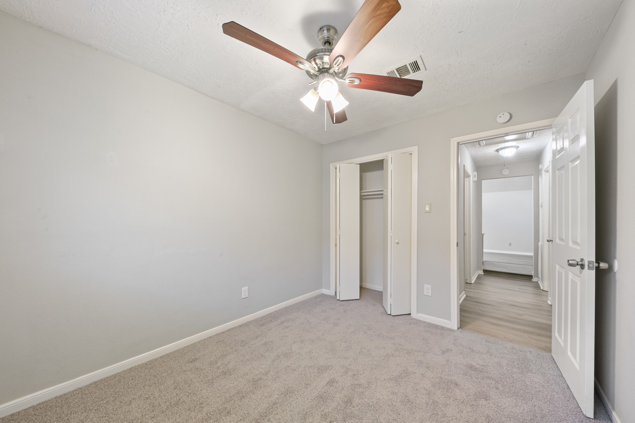 10530 Rippling Fields Drive Houston, TX 77064 - Photo 30 of 30 an empty room with closet and a ceiling fan
