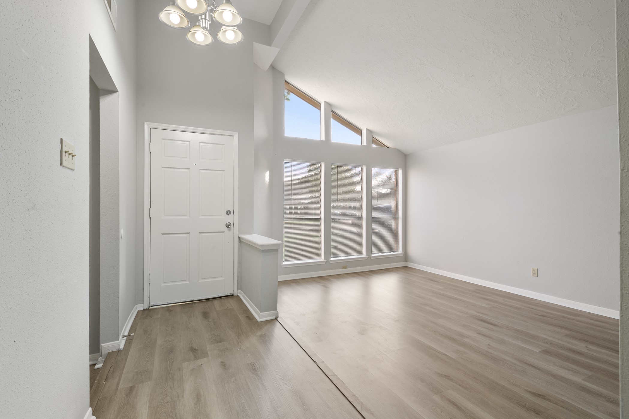 10530 Rippling Fields Drive Houston, TX 77064 - Photo 5 of 30 a view of an empty room with wooden floor and a window