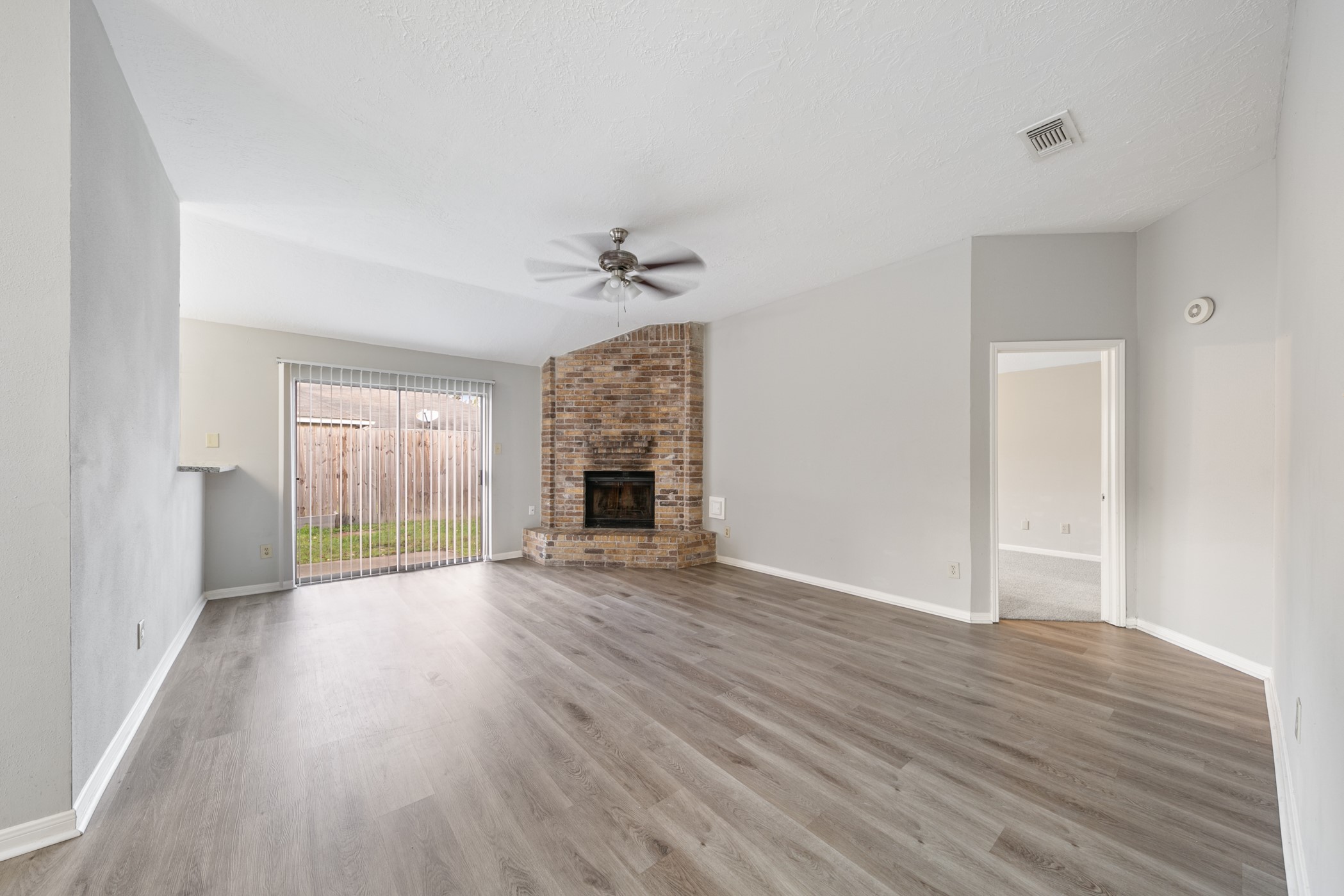 10530 Rippling Fields Drive Houston, TX 77064 - Photo 9 of 30 a view of empty room with wooden floor and fan