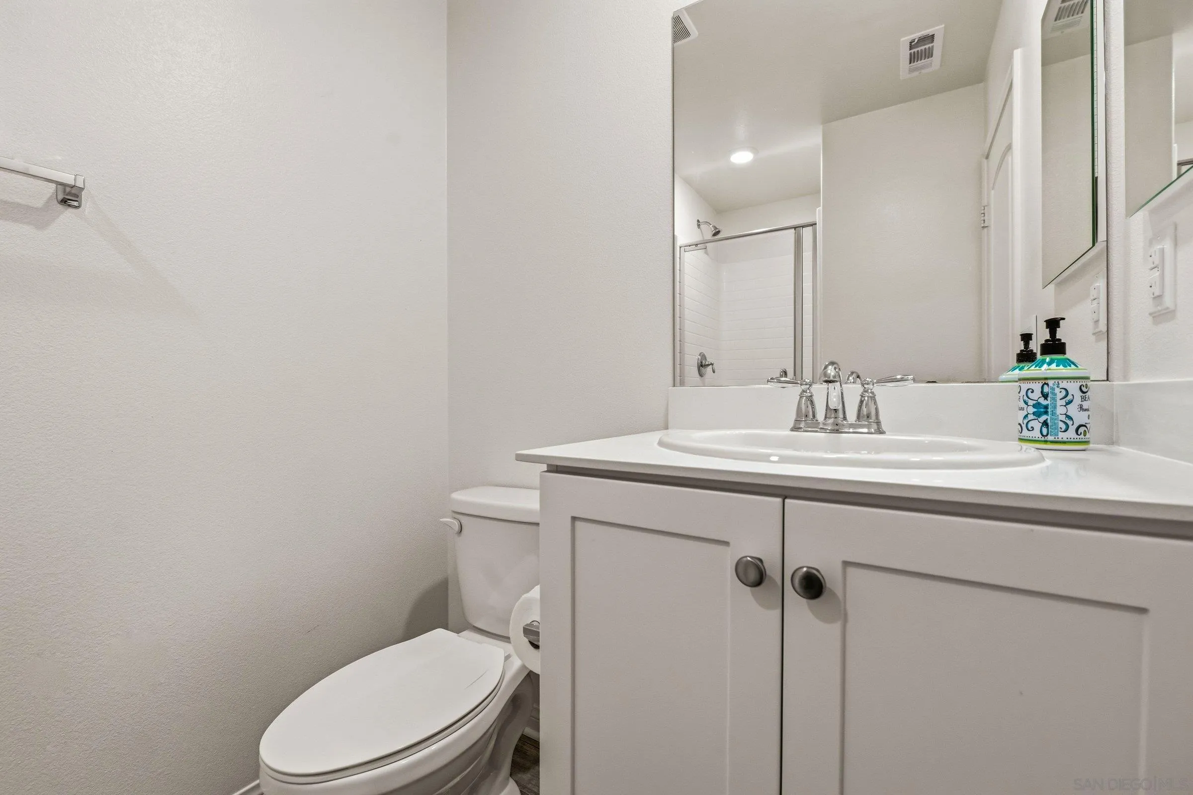 5429 Meridian Place Bonsall, CA 92003 - Photo 11 of 31 a bathroom with a toilet sink and mirror
