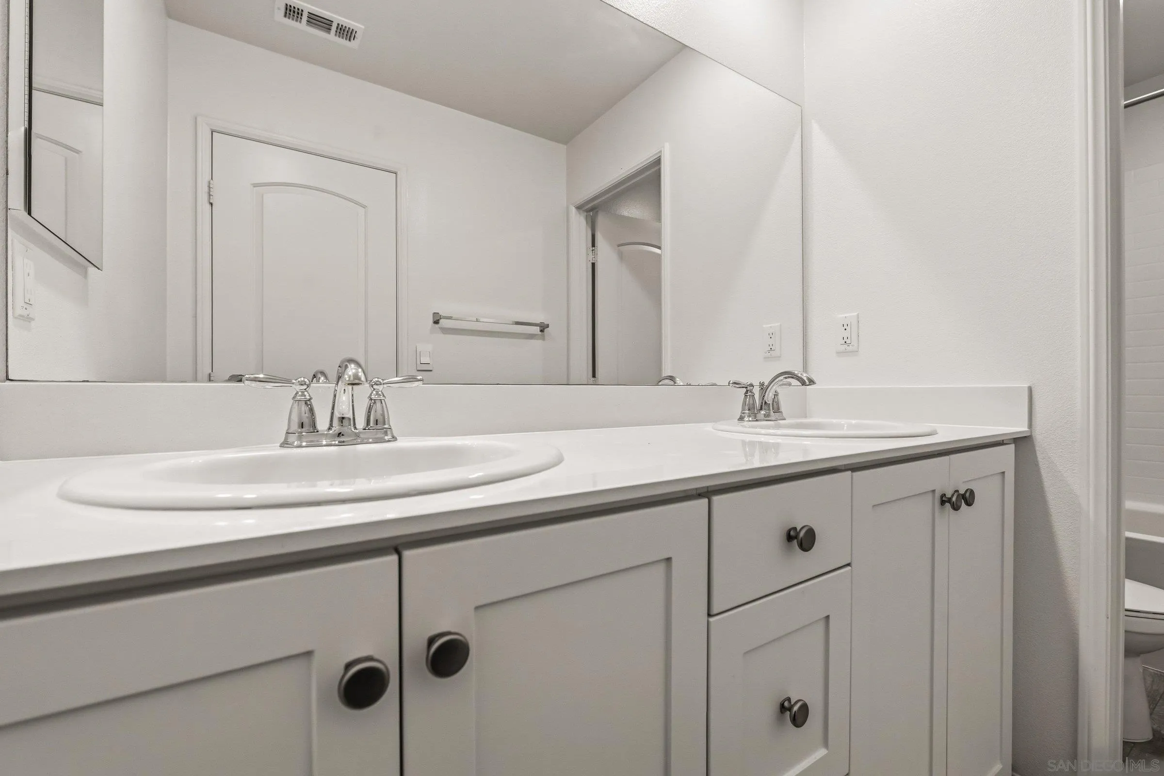 5429 Meridian Place Bonsall, CA 92003 - Photo 25 of 31 a bathroom with a sink and a mirror