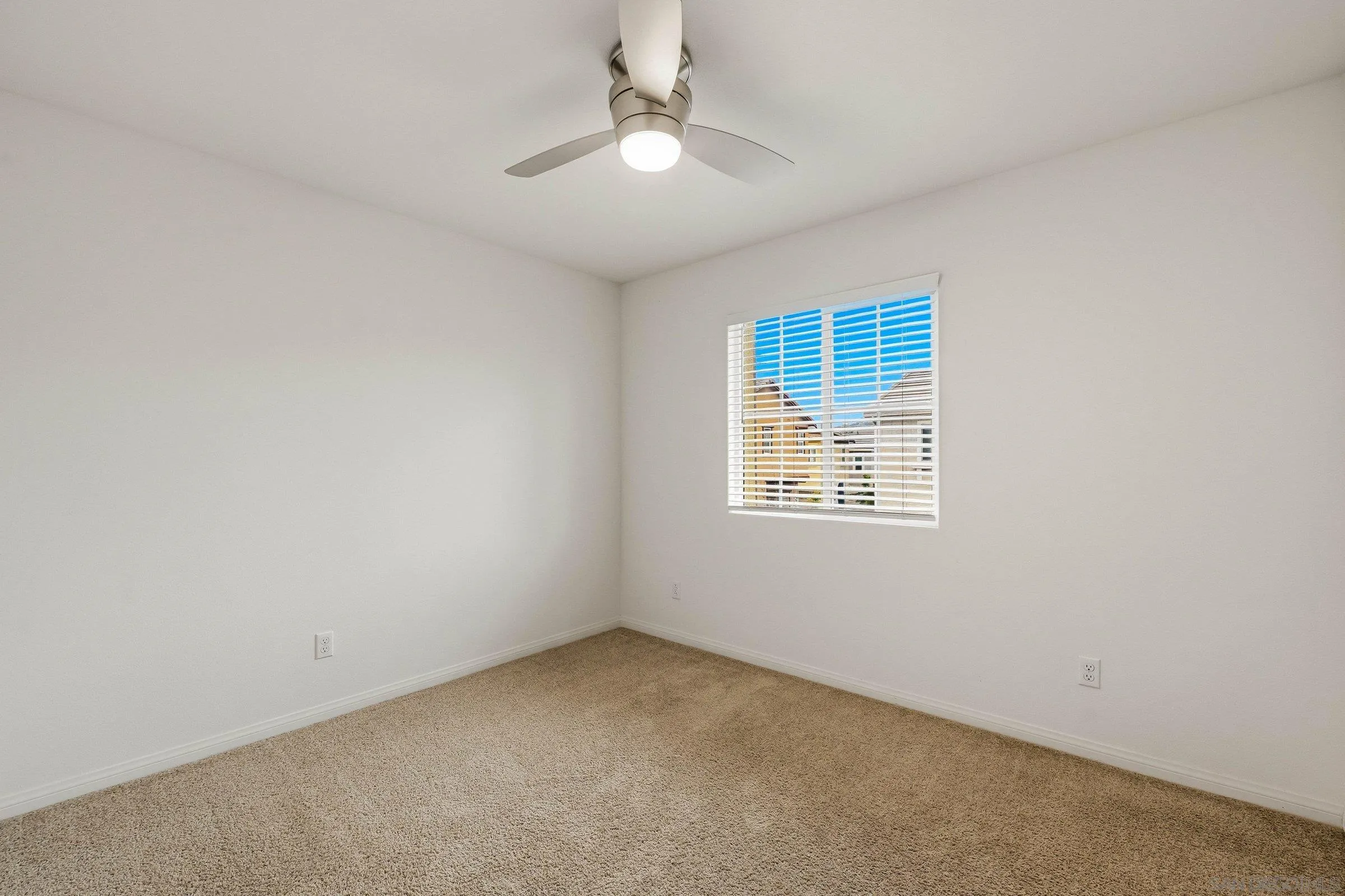 5429 Meridian Place Bonsall, CA 92003 - Photo 27 of 31 an empty room with a window and a ceiling fan