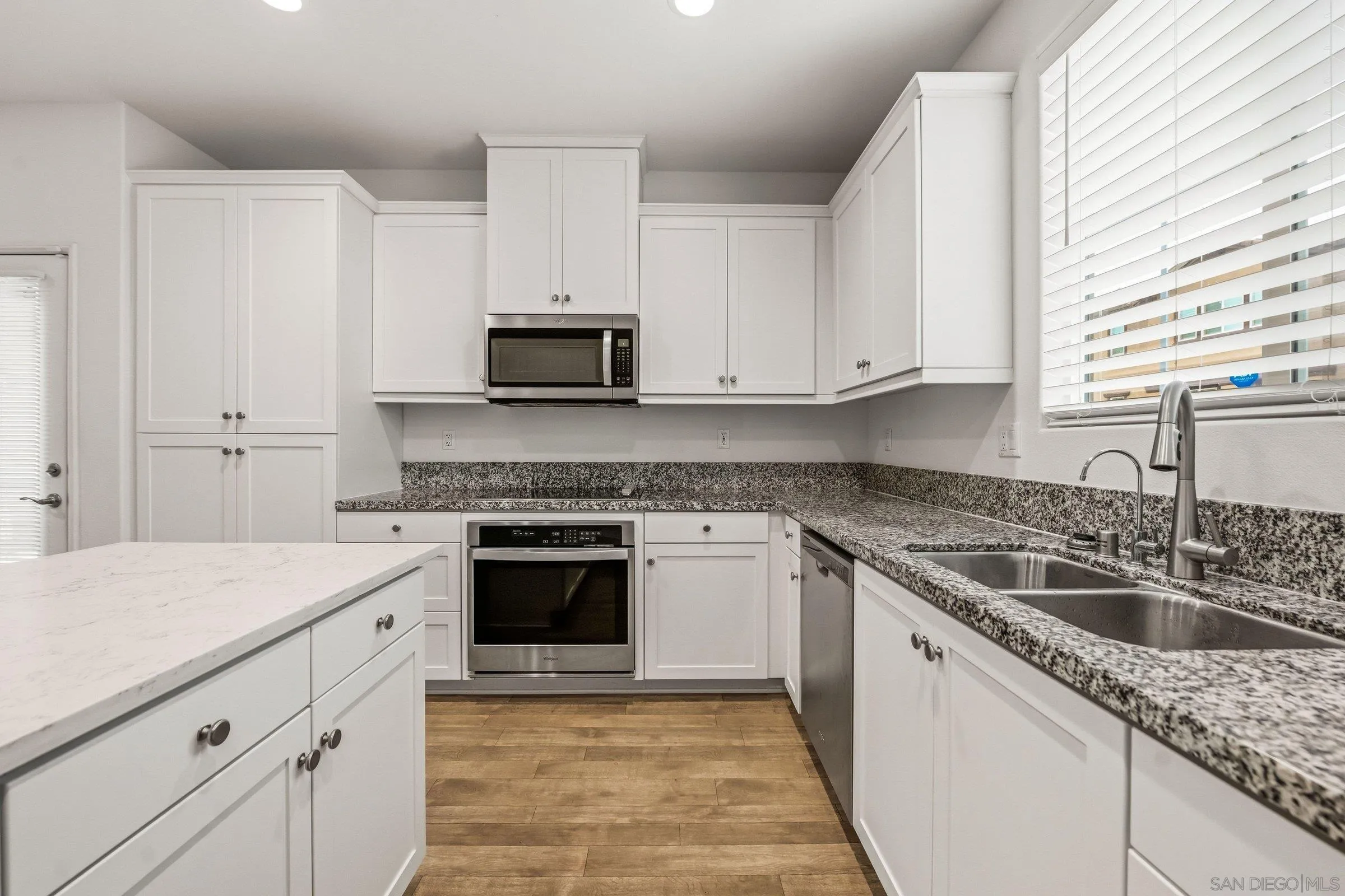 5429 Meridian Place Bonsall, CA 92003 - Photo 3 of 31 a kitchen with cabinets appliances a sink and a window