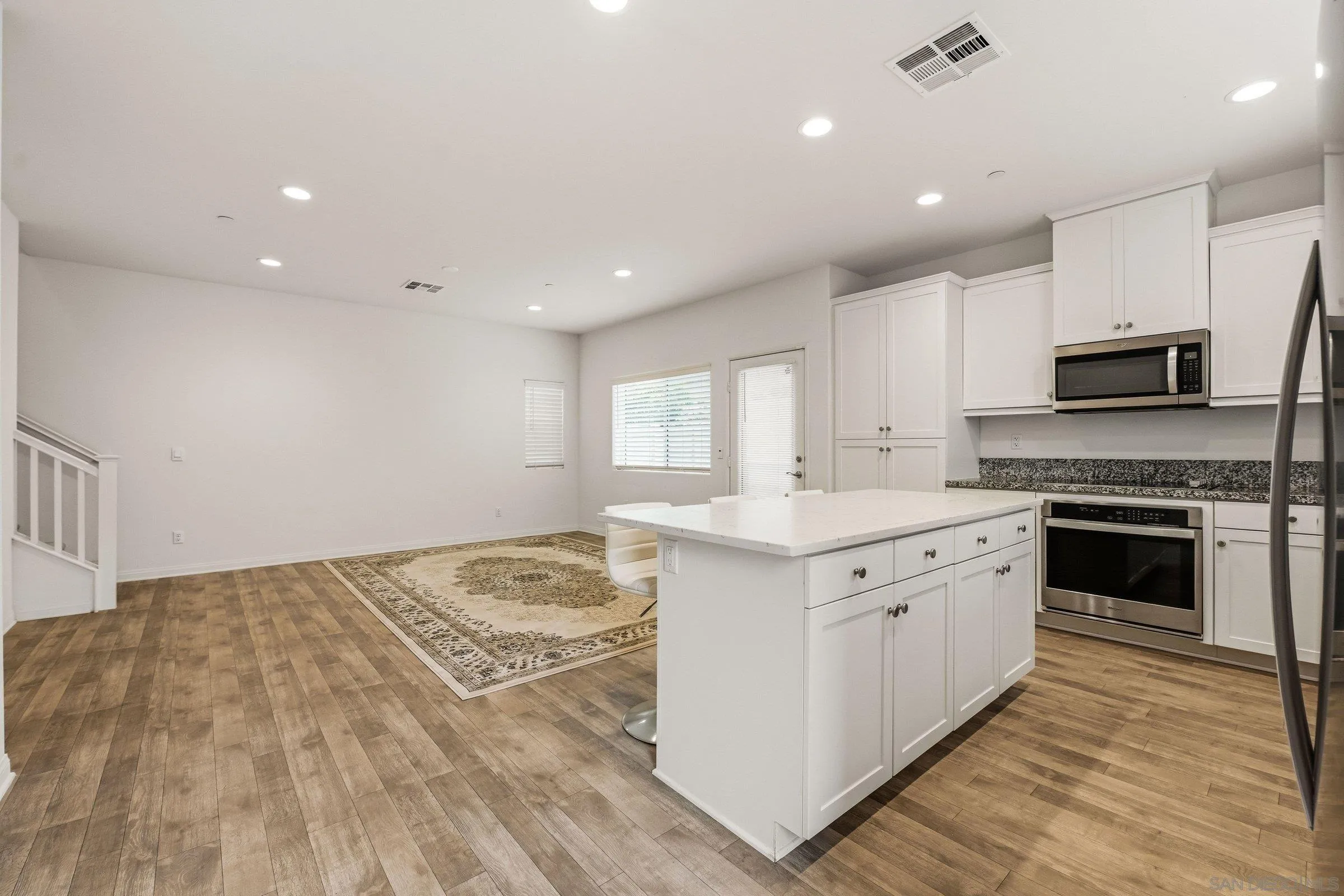 5429 Meridian Place Bonsall, CA 92003 - Photo 6 of 31 a kitchen with a stove a sink and a microwave