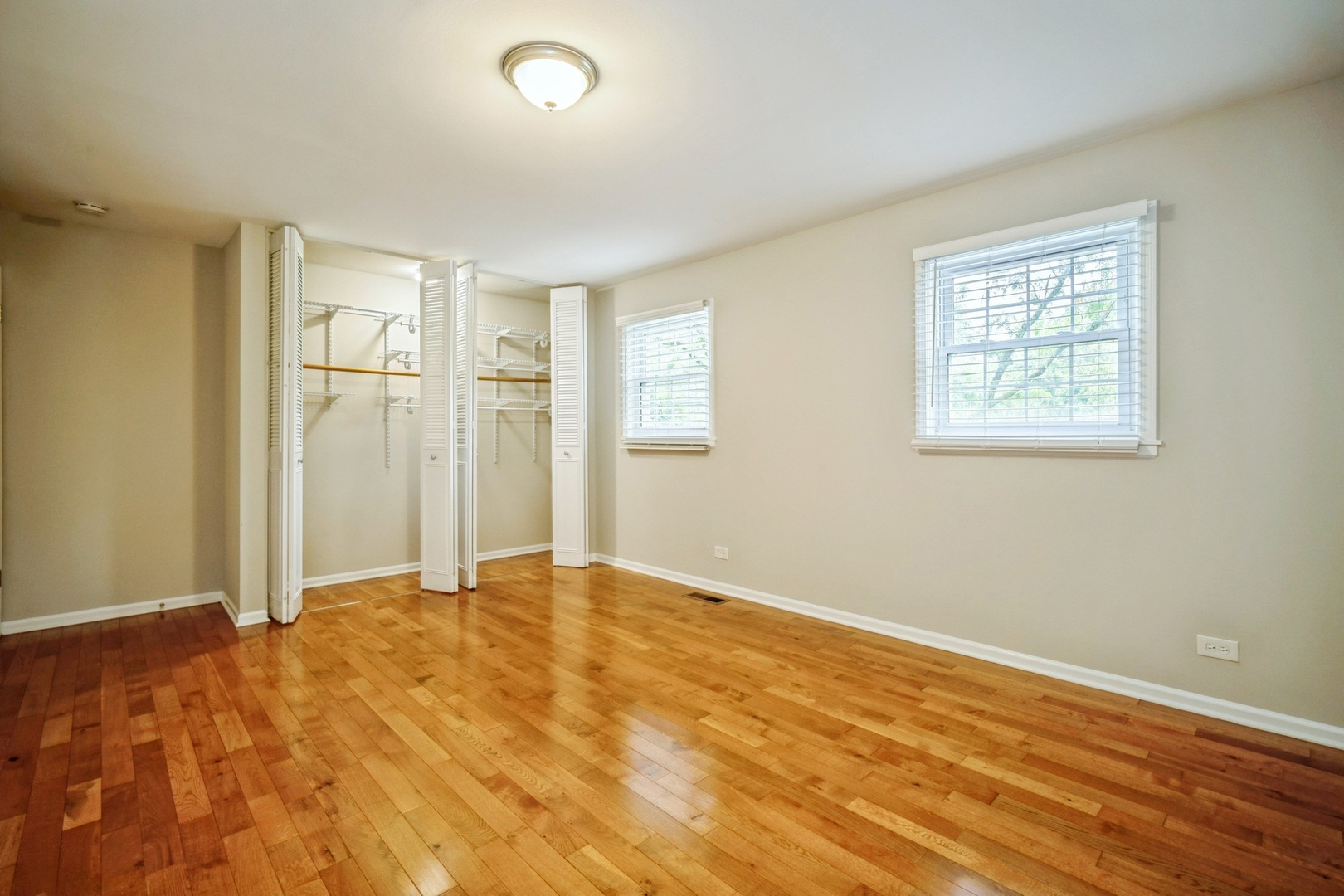 2154 Rugen Road, Unit C Glenview, IL 60026 - Photo 10 of 17 a view of an empty room with wooden floor and a window