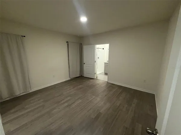 a view of hallway with wooden floor