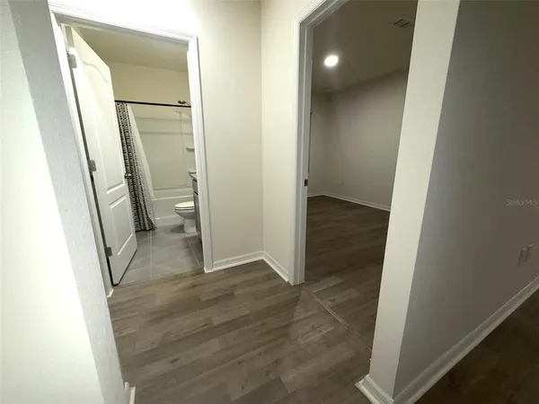 a view of a bathroom from a hallway