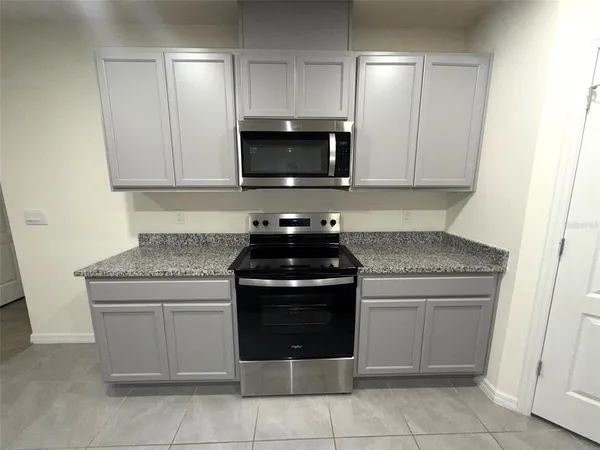 a kitchen with a stove and a microwave
