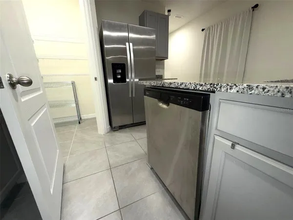 a kitchen with granite countertop a refrigerator and a stove