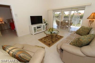 6650 Beach Resort Drive, Unit 908 Naples, FL 34114 - Photo 8 of 15 a living room with furniture and a flat screen tv