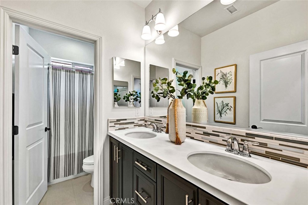 222 Barnes Road Tustin, CA 92782 - Photo 16 of 31 a bathroom with a sink double vanity and a mirror