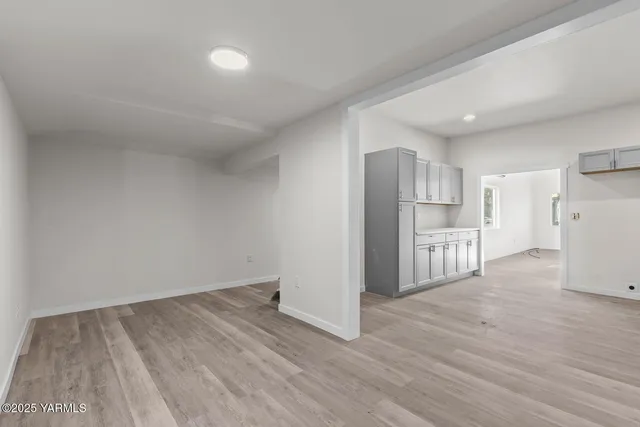 a view of kitchen with refrigerator cabinets and wooden floor
