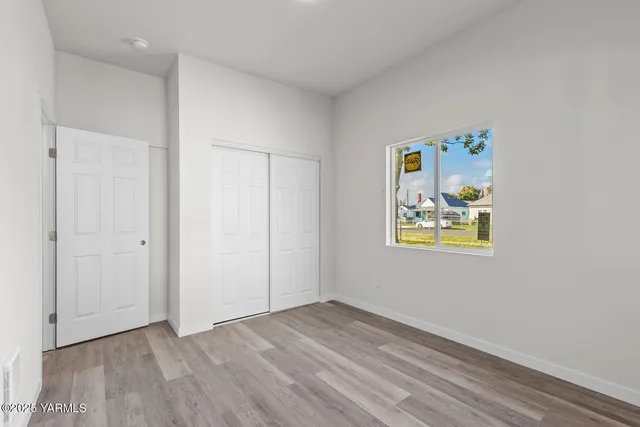 a view of an empty room and wooden floor