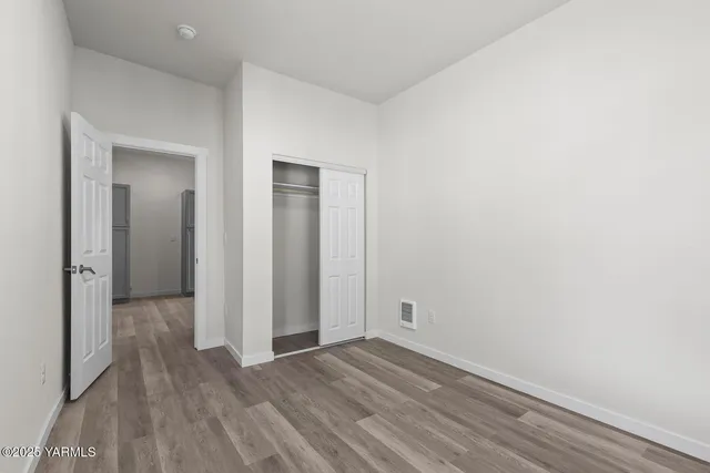 a view of a room with wooden floor