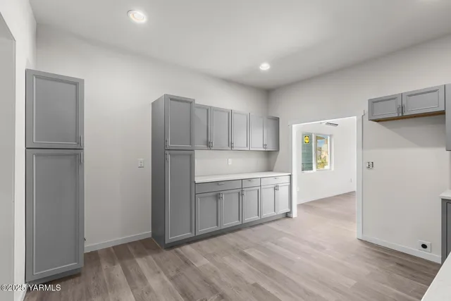 a kitchen with a refrigerator sink and cabinets