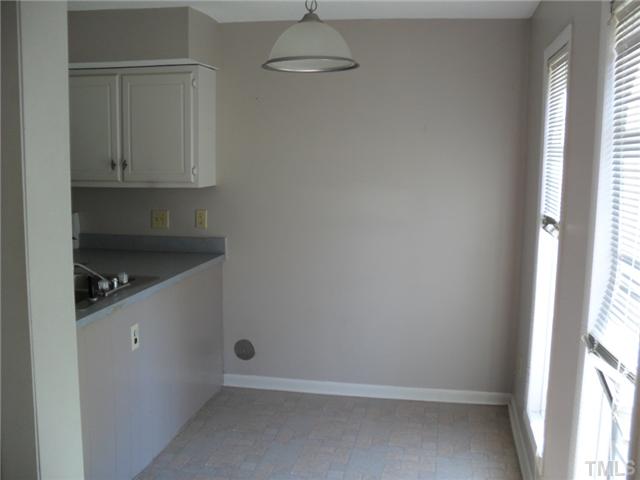 1304 Seaton Road, Unit T2 Durham, NC 27713 - Photo 3 of 8 a kitchen with white cabinets and a window