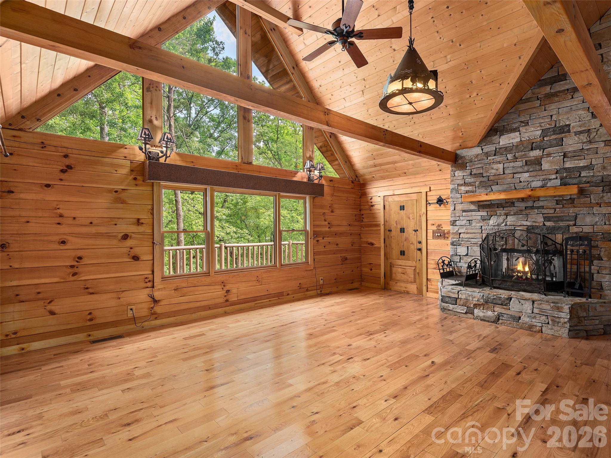 413 Green Hills Road Mill Spring, NC 28756 - Photo 7 of 48 a view of an empty room with a fireplace and a window