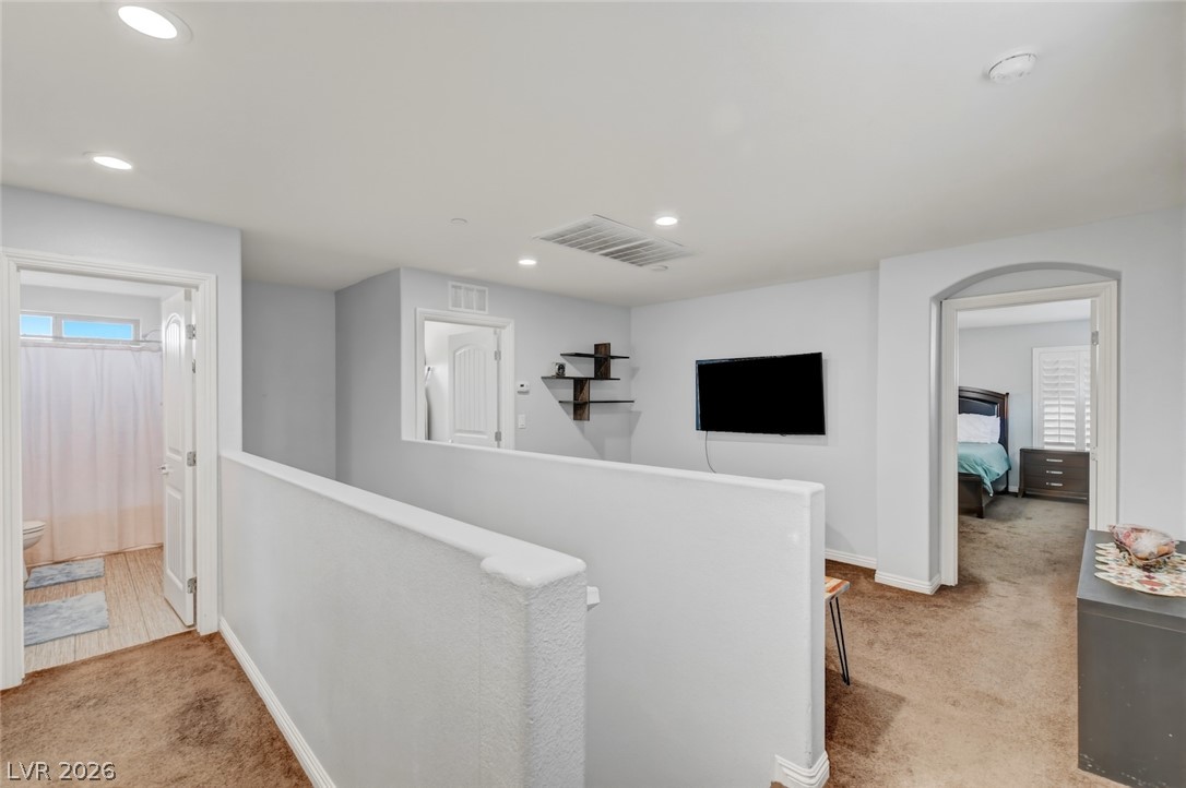 48 Jasmine Point Street Henderson, NV 89074 - Photo 29 of 62 A well-lit landing provides access to secondary bedrooms and a bathroom.