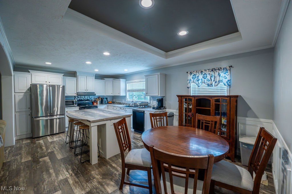 560 Wine Road Elizabeth, WV 26143 - Photo 17 of 50 Kitchen featuring ornamental molding, white cabinetry, black appliances, dark wood-type flooring, and recessed lighting