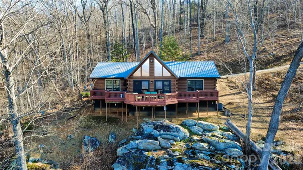 a front view of house with swimming pool and outdoor seating