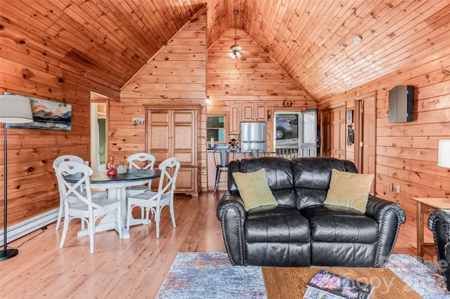 a dining room with furniture and wooden floor