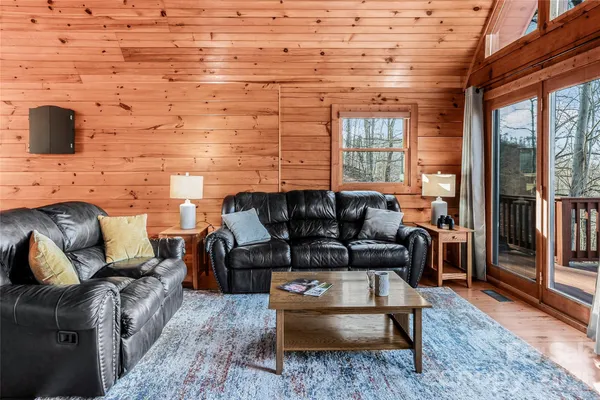 a living room with furniture wooden floor and a flat screen tv