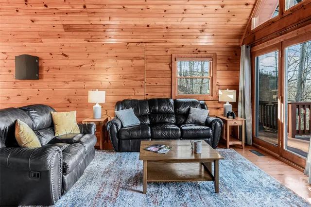a living room with furniture wooden floor and a flat screen tv