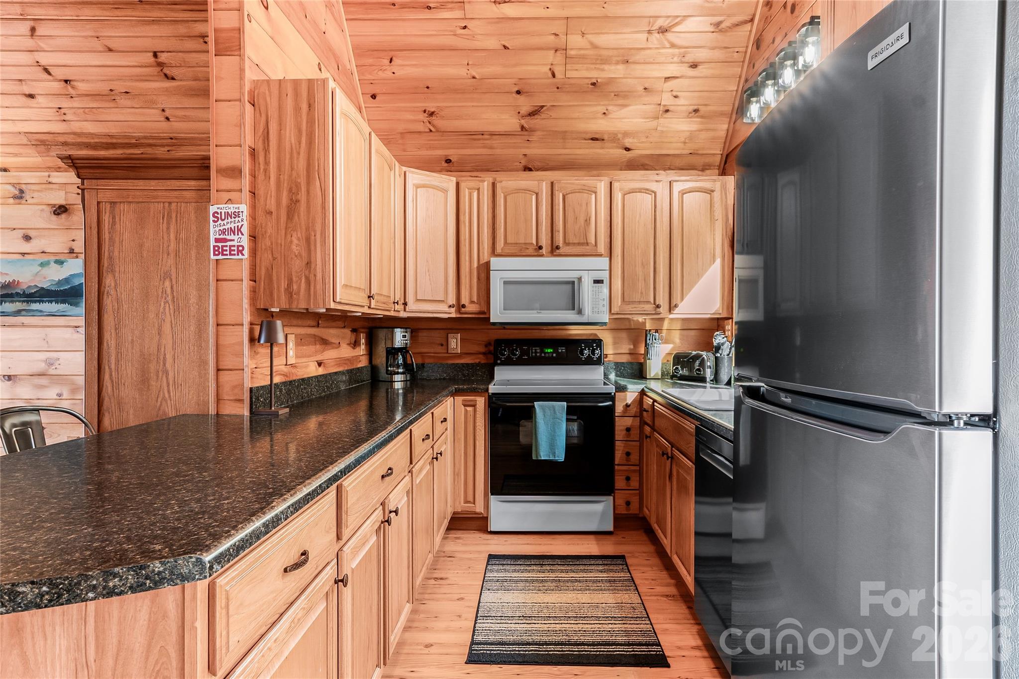 206 Amelia Lane Bostic, NC 28018 - Photo 22 of 48 a kitchen with stainless steel appliances granite countertop a stove a sink and a refrigerator