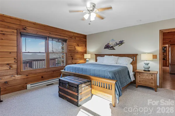 a spacious bedroom with a bed and a window