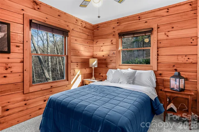 a bed sitting in front of a glass door