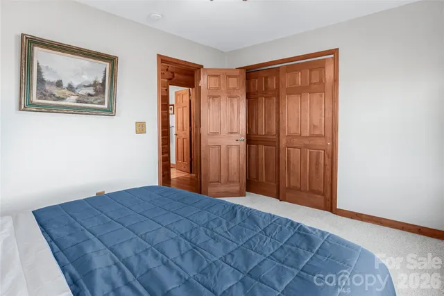 a view of a bedroom with wooden floor and closet