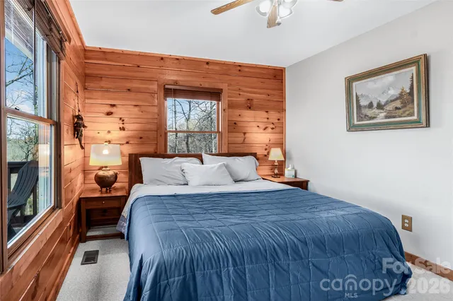 a large bed sitting in a bedroom next to a window