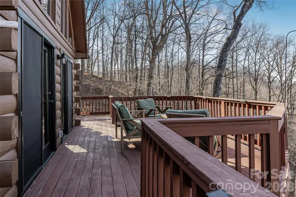 a view of balcony with furniture and wooden floor
