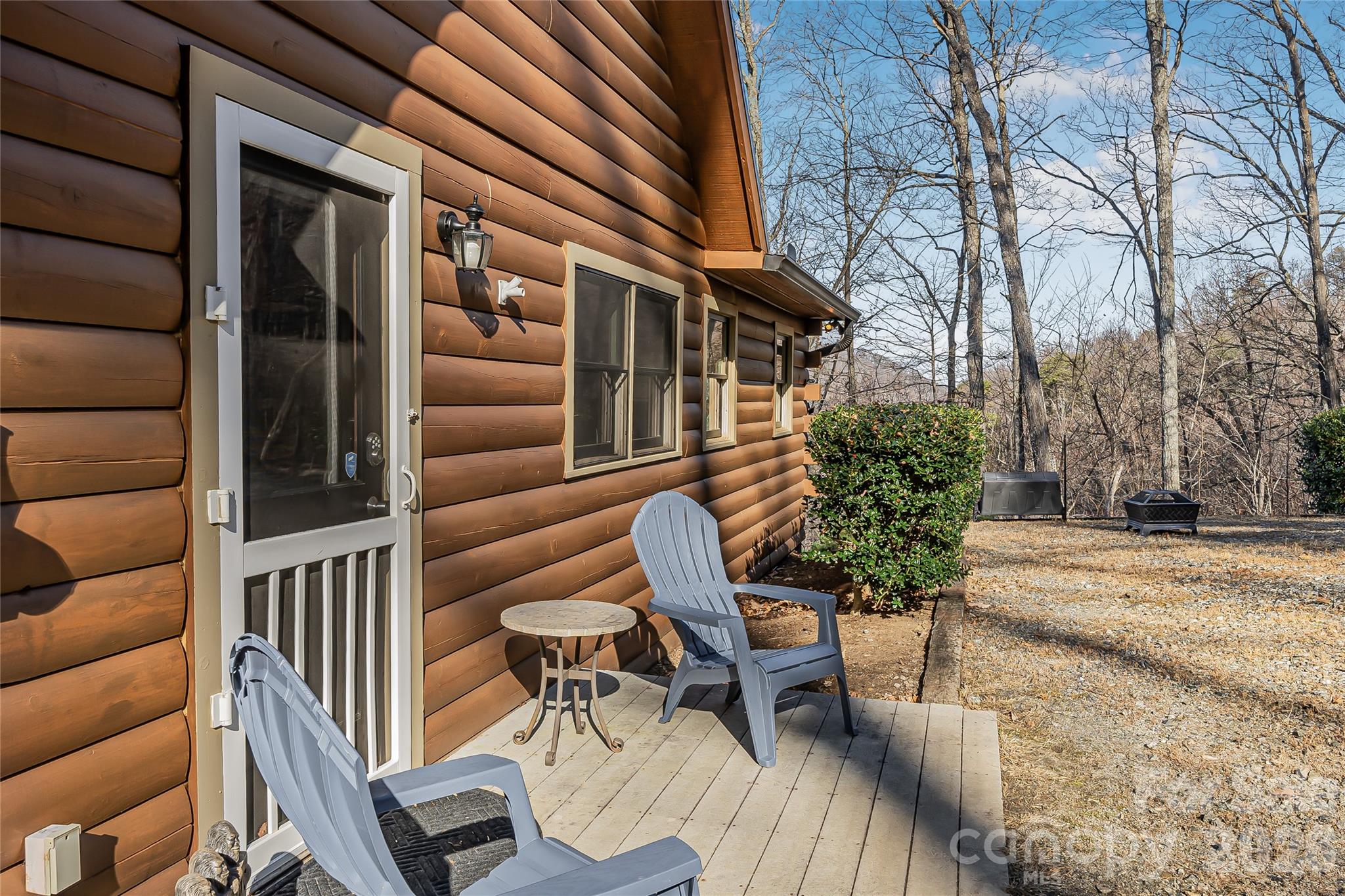206 Amelia Lane Bostic, NC 28018 - Photo 48 of 48 a view of a patio with table and chairs and potted plants with wooden floor and fence