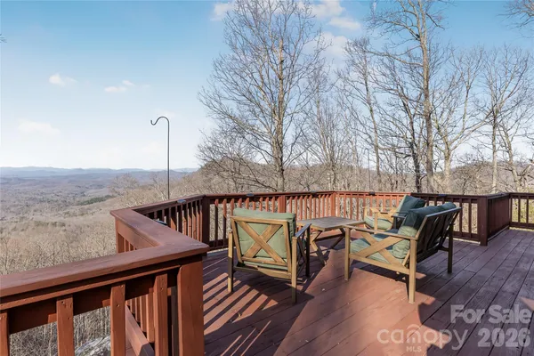 a view of a roof deck with wooden fence and floor