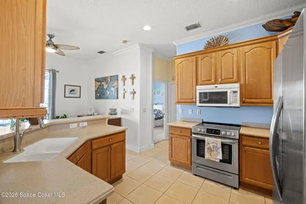 a kitchen with stainless steel appliances granite countertop a stove top oven a sink dishwasher and a refrigerator