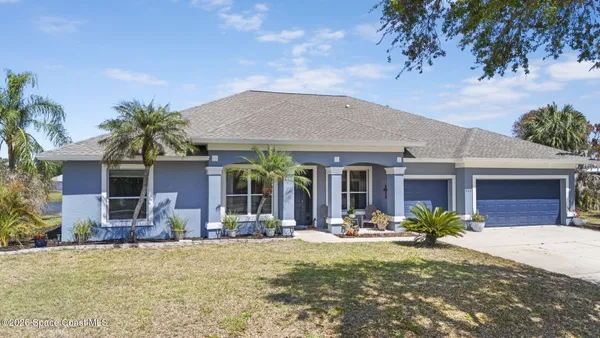 a front view of house with yard outdoor seating and barbeque oven
