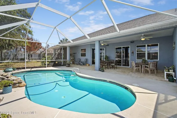 a view of a swimming pool with sitting area