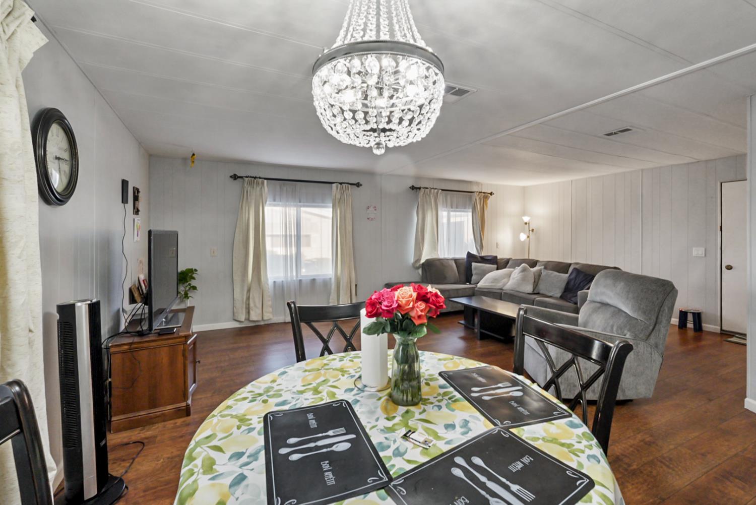 1400 North Tully Road, Unit 137 Turlock, CA 95380 - Photo 13 of 37 a living room with furniture and a chandelier