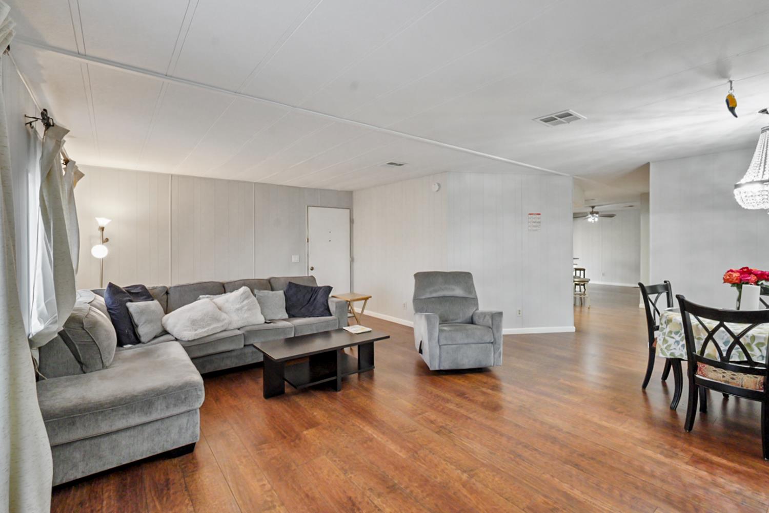 1400 North Tully Road, Unit 137 Turlock, CA 95380 - Photo 14 of 37 a living room with furniture and wooden floor