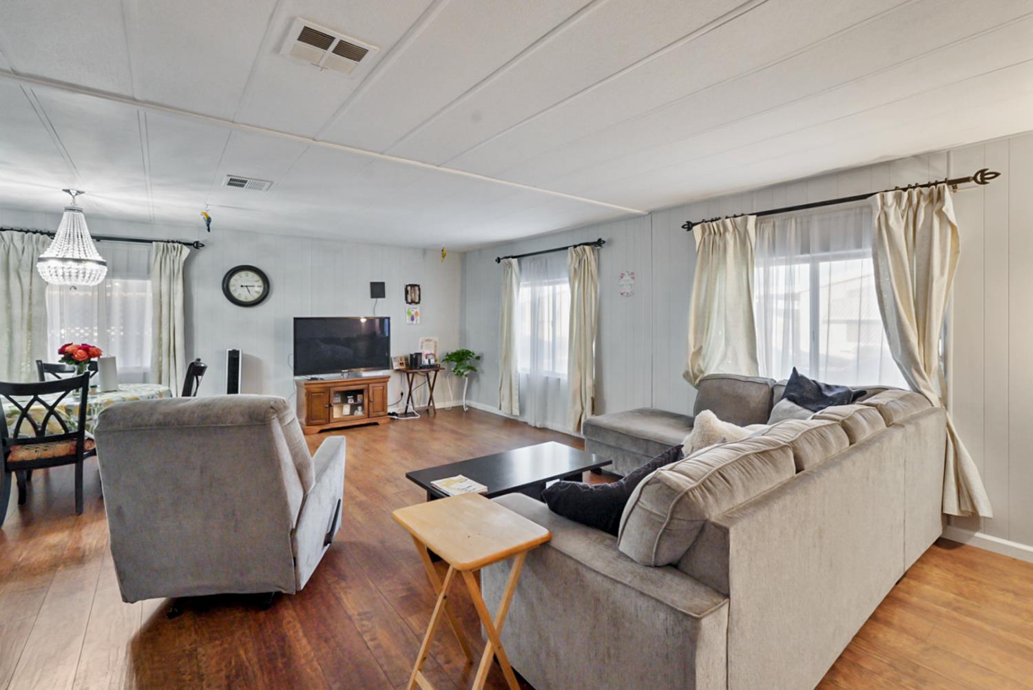 1400 North Tully Road, Unit 137 Turlock, CA 95380 - Photo 15 of 37 a living room with furniture and wooden floor