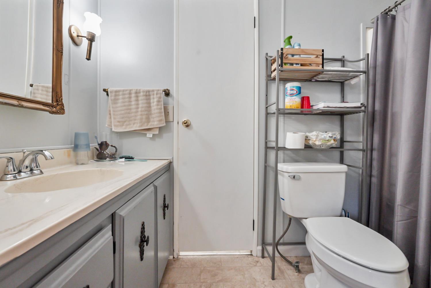 1400 North Tully Road, Unit 137 Turlock, CA 95380 - Photo 19 of 37 a bathroom with a granite countertop toilet sink and a mirror