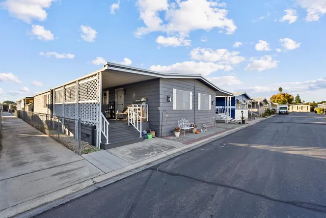 a front view of house with a garden