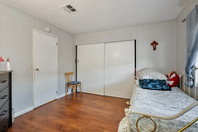 a bedroom with bed and window