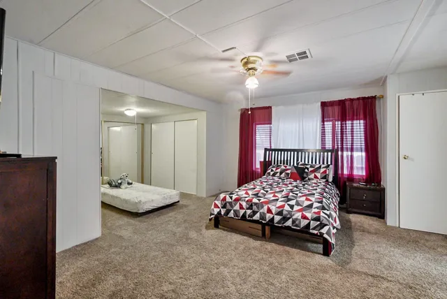 a bedroom with bed and balcony