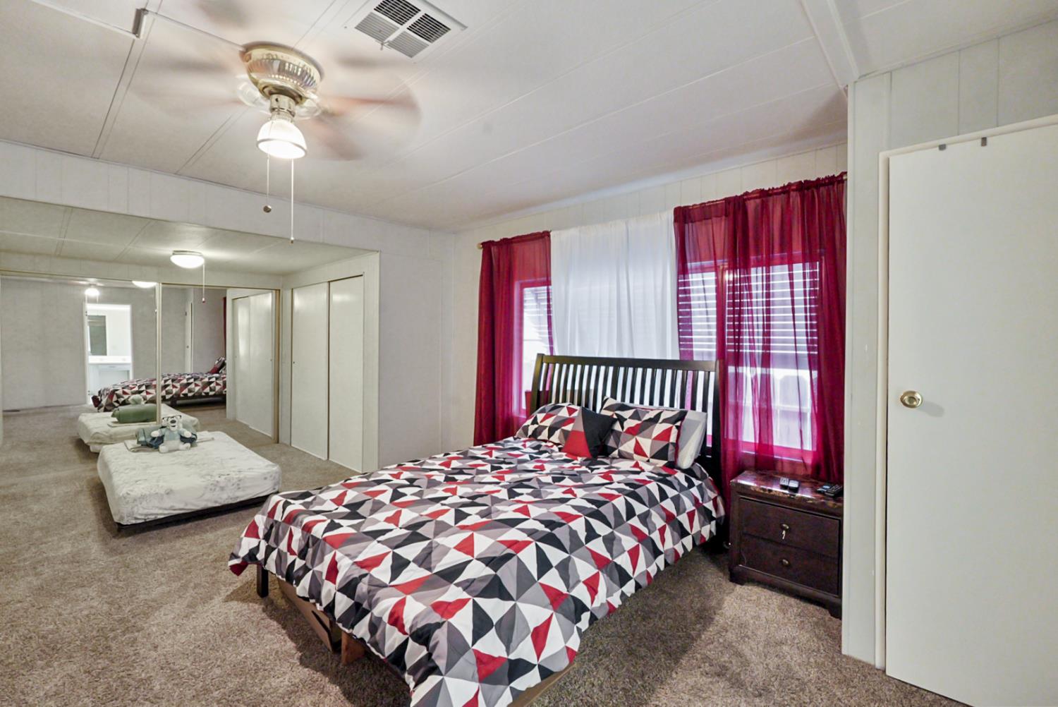 1400 North Tully Road, Unit 137 Turlock, CA 95380 - Photo 23 of 37 a bedroom with bed and balcony