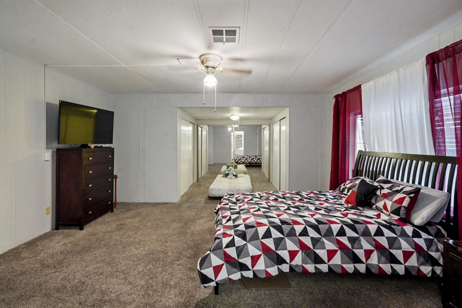 1400 North Tully Road, Unit 137 Turlock, CA 95380 - Photo 26 of 37 a bedroom with a bed and a television