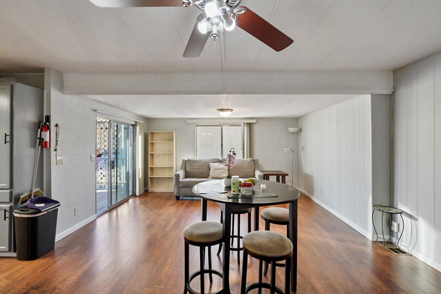 1400 North Tully Road, Unit 137 Turlock, CA 95380 - Photo 5 of 37 a view of a dining room with furniture window and wooden floor