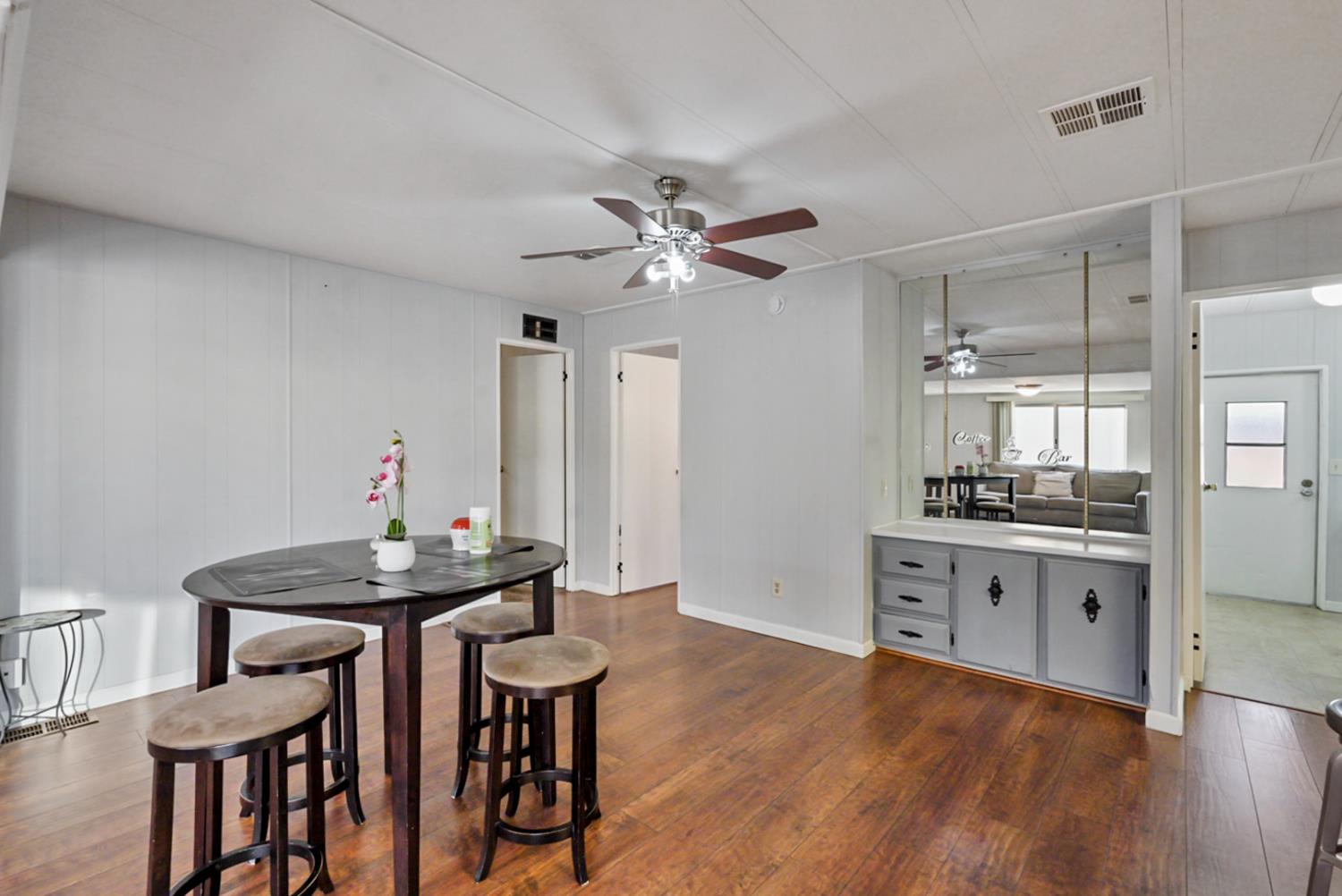 1400 North Tully Road, Unit 137 Turlock, CA 95380 - Photo 7 of 37 a view of a dining room with furniture and wooden floor